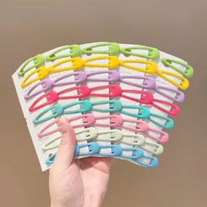 Close-up of colorful matte BB hair clips in macaron colors on white display cards.