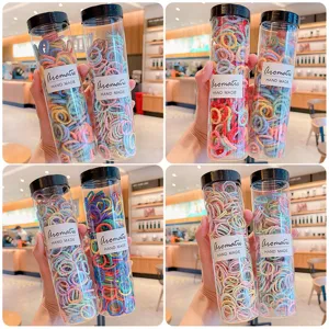 Assorted colorful baby elastic hair bands set in transparent storage bottles for styling