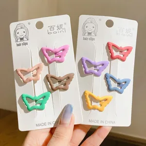 Close-up of matte butterfly hair clips in various pastel colors on display cards