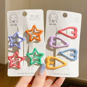 Close-up of colorful star and heart hair clips in matte pastel colors for girls
