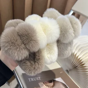 Detailed close-up showing soft plush texture of rabbit fur hair claw clips in neutral colors