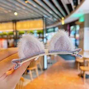 Close-up detail of fuzzy animal ear hair clips with soft plush texture for cute girls' hair