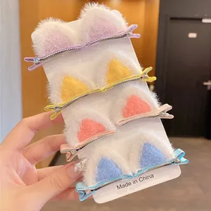 Close-up detail of cute multi-colored fuzzy animal ear hair clips for girls on display card