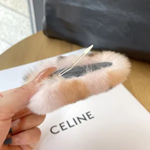 Detail view of plush rabbit fur hair clip back with metal snap fastener mechanism