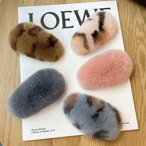 Assorted plush rex rabbit fur hair clips displayed on a white magazine background
