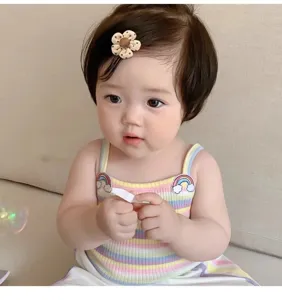 Close-up of a cute floral baby hair clip worn on an infant girl's hair