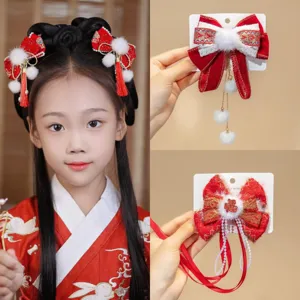 Traditional Chinese New Year hair clips for girls with red bows and elegant tassels.