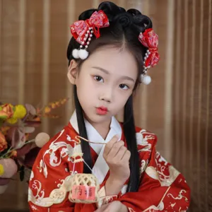 Detail of a young girl wearing festive red Chinese style bow hair clips with white pearl tassels