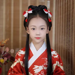 Detail of Chinese style red hair clip with bow and tassels on a young girl