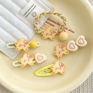 Close-up of cute yellow star hair clips and hair tie set with sweet heart accents