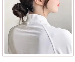 Macro detail showing a natural dark brown synthetic hair bun on a female model