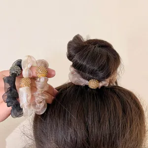 Elegant rhinestone mesh scrunchies in neutral colors, shown for hair bun styling.