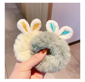 Detailed close-up of plush rabbit ear hair scrunchies showing soft fluffy texture and embroidery