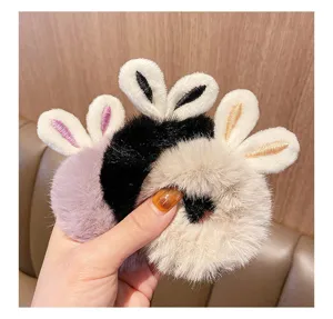Detail of soft plush hair scrunchies with cute bunny ears in three different colors