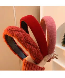 Close-up of three festive red and pink textured velvet headbands for women's hair.