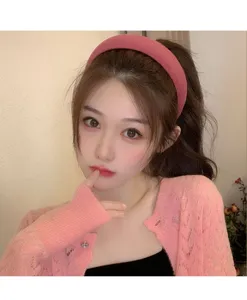 Fashionable pink velvet wide headband worn by an Asian model for a retro high top look