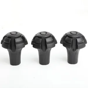Detail view of durable black rubber trekking pole tips, anti-slip hiking stick protective covers.