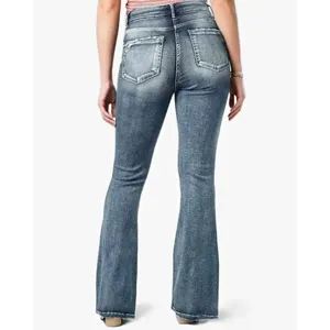 Detail view of vintage washed blue flared denim jeans featuring mid-rise and pocket back styling.