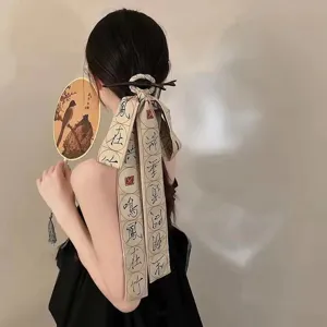 Back view of a model wearing a traditional ribbon hairpin with Chinese calligraphy.