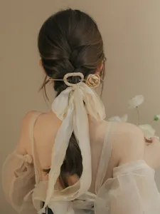 Elegant ancient style hair stick with cream ribbon on braided hair model back view