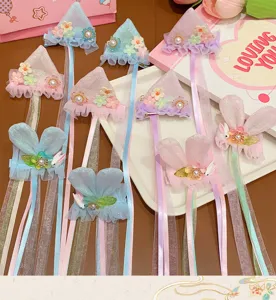Macro view of exquisite children's hair clips featuring rabbit ears and flowing ribbons