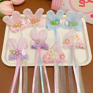Detailed macro view of cute children's rabbit ear hair clips with long colorful streamers