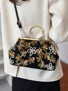 Elegant vintage embroidered floral shell handbag with circular gold handle and black strap