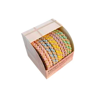 Set of 10 candy colored braided hair bands with high elasticity presented in a pink box