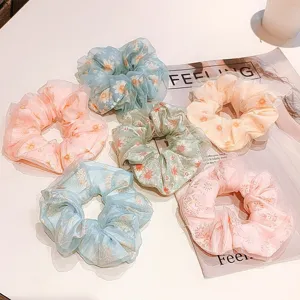 Detailed view of assorted floral chiffon scrunchies with sheer double-layer design