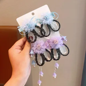 Detail of Hanfu hair clips featuring flowers, black hair loops, and bell tassels