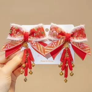 Close-up of traditional Chinese New Year red bow hair clips with tassels and bells