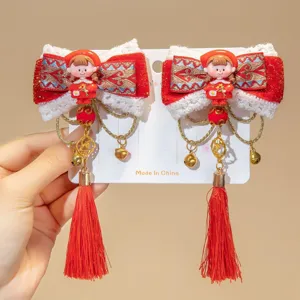 Close-up of red Chinese New Year hair clips with bows, tassels, and cute girl figures.