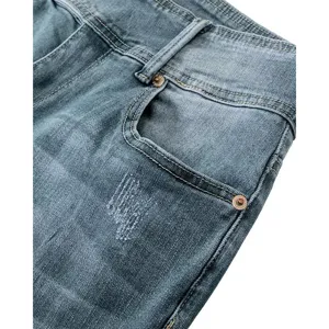 Detailed view of vintage washed high-waisted denim jeans featuring pocket and buttons.