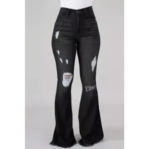 Detailed close-up view of high-waist black distressed bell-bottom jeans featuring ripped knee design.