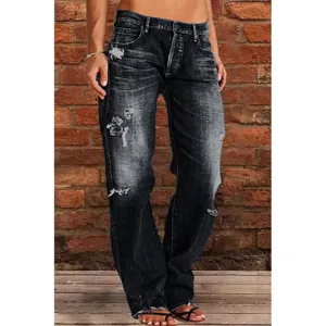 Detailed shot of women's dark distressed straight leg jeans featuring vintage wash and rips.