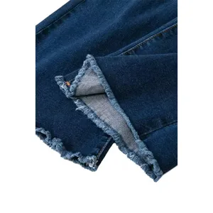 Close-up detail of dark blue denim jeans featuring a stylish frayed split hem design.