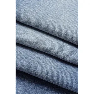 Close-up detail of blue denim fabric showing clear twill texture and washed soft material.