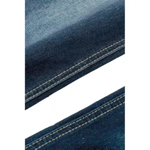 Blue denim jeans fabric detail featuring durable texture and neat double stitching.