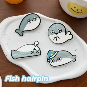 Close-up of cute cartoon Sacabambaspis fish hairpins on a white plate