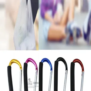 Details showing oversized aluminum carabiners with foam grips used for bags and skates.