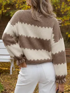 Back view detail of women's color-blocked knit sweater with long sleeves and cozy texture.