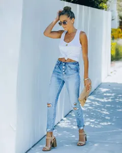 Light blue high waisted ripped skinny jeans for women, button fly stretch denim trousers.