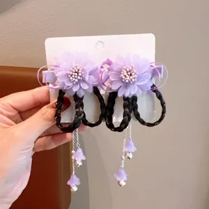 Macro view of Chinese style kids hair clips featuring purple flowers and braided tassels