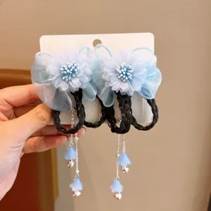 Close-up of blue mesh flower hair clip with black braided wig loops and bells