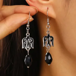 Close-up of Kazakh style ethnic drop earrings with black enamel and faceted beads