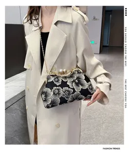 Elegant black floral embroidery clutch bag with pearl kiss-lock and gold chain strap
