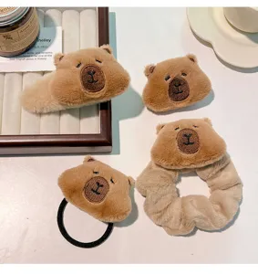 Detailed view of Capybara plush hair accessories set including clips and scrunchie