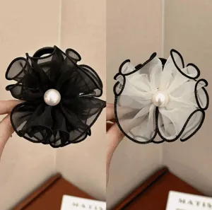 Macro view of elegant mesh flower hair claw clips with center pearl detail and black piping