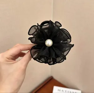 Close-up of 8cm black mesh flower hair claw clip featuring an elegant white pearl