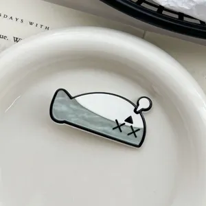 Close-up of a creative cartoon Sacabambaspis hair clip on an elegant white plate